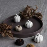Herbstdekoration in Form verschiedener Kürbisse aus Keramik